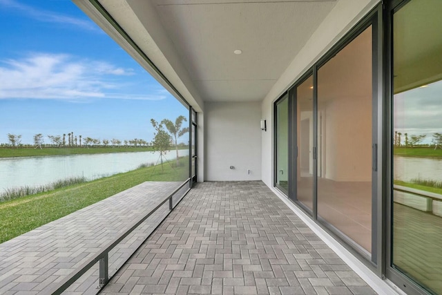 balcony with a water view and a patio