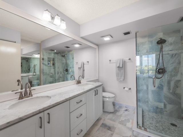 full bath with a stall shower, visible vents, a sink, and toilet