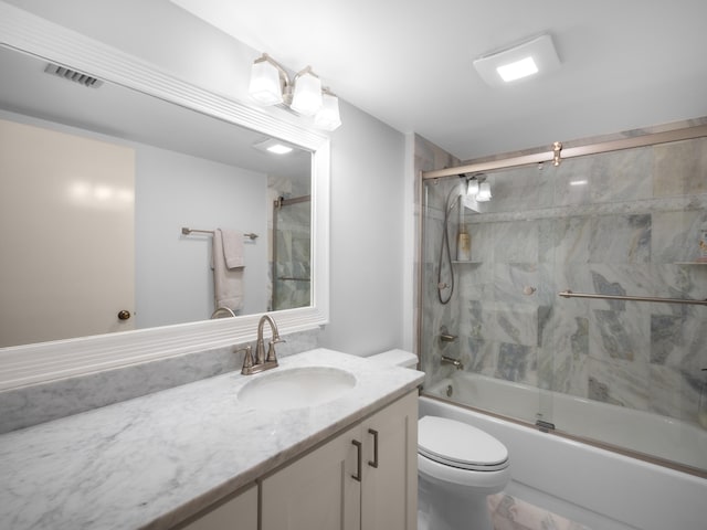 full bathroom featuring visible vents, vanity, toilet, and bath / shower combo with glass door