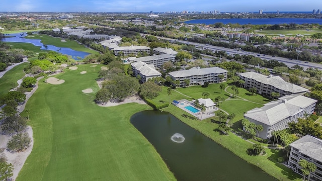 birds eye view of property featuring a water view and view of golf course