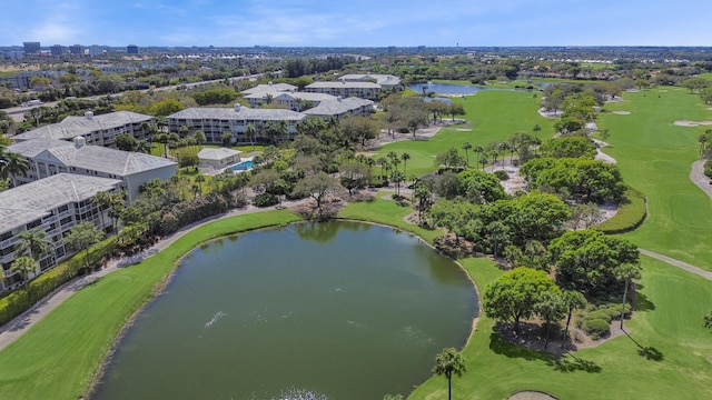 drone / aerial view with view of golf course and a water view