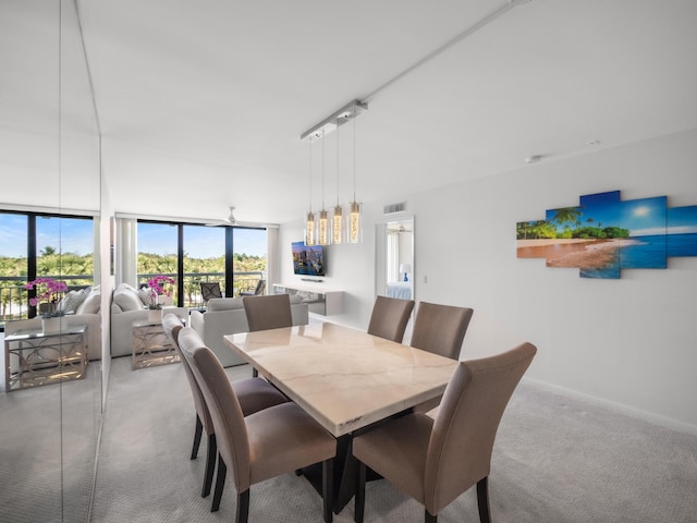 dining room with carpet floors, visible vents, and baseboards