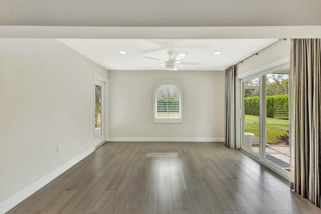 empty room with ceiling fan, a healthy amount of sunlight, and wood-type flooring