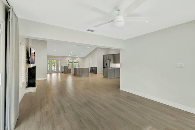 unfurnished living room with ceiling fan and light wood-type flooring