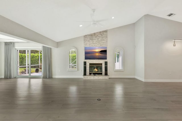 unfurnished living room featuring a stone fireplace, ceiling fan, high vaulted ceiling, and wood-type flooring