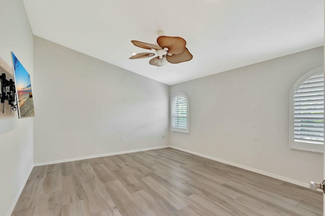 unfurnished room featuring light hardwood / wood-style floors, ceiling fan, and lofted ceiling