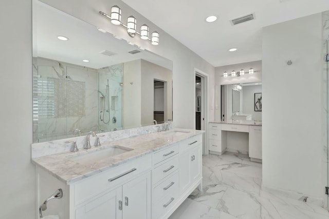 bathroom featuring vanity and a shower with shower door