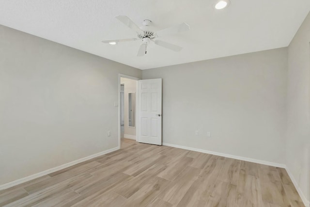 unfurnished room featuring light wood-type flooring and ceiling fan