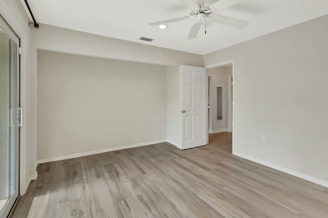 spare room featuring ceiling fan and light hardwood / wood-style floors