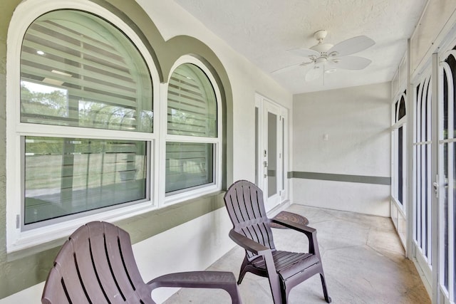 sunroom / solarium featuring ceiling fan