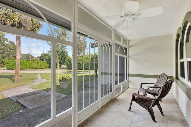 sunroom featuring ceiling fan