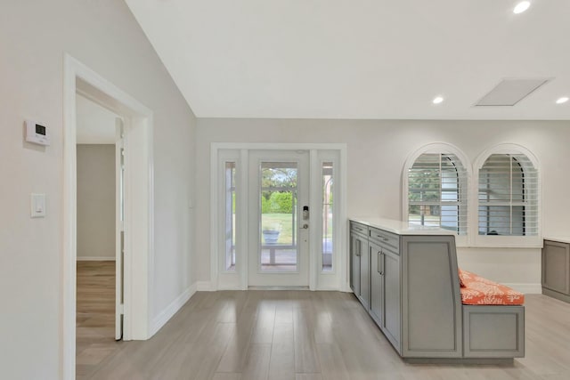 entrance foyer featuring lofted ceiling and light wood-type flooring