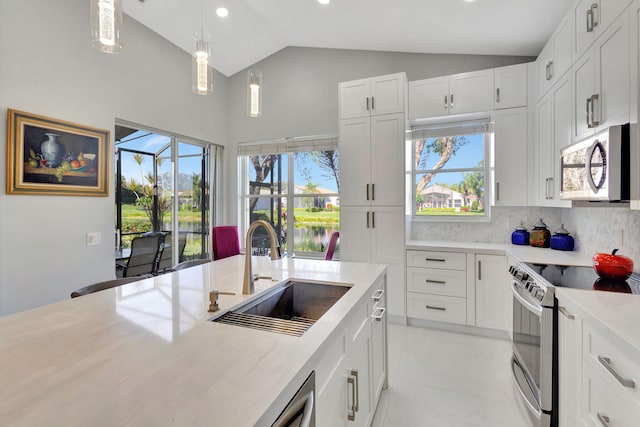 kitchen with a wealth of natural light, white cabinetry, sink, vaulted ceiling, and stainless steel electric range