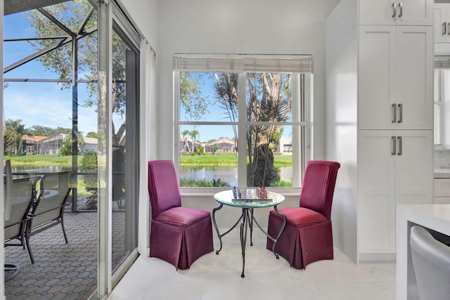 sitting room featuring a healthy amount of sunlight and a water view