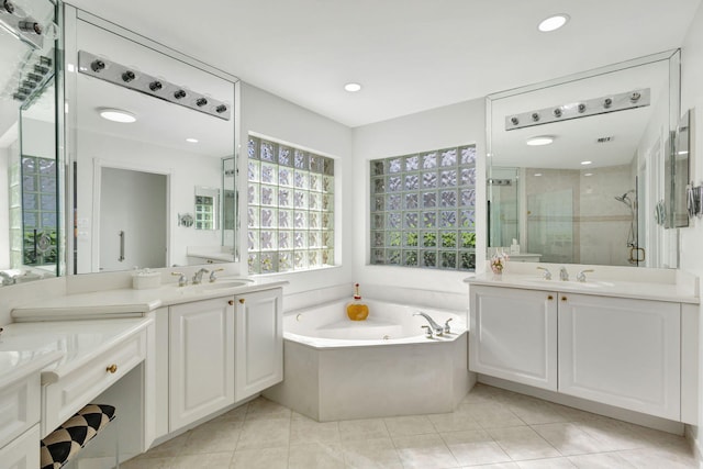 bathroom featuring tile patterned flooring, vanity, and plus walk in shower