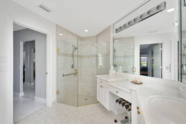 bathroom with tile patterned floors, vanity, and a shower with shower door