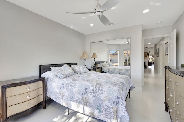 bedroom with ceiling fan and a closet