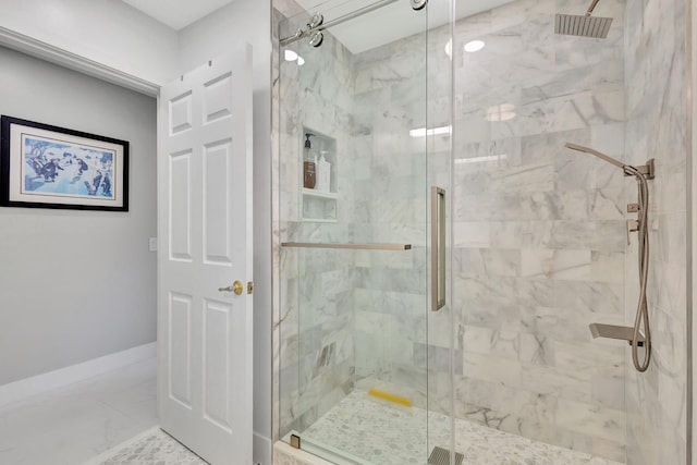 bathroom featuring a shower with shower door