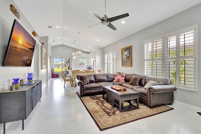 living room with ceiling fan, a healthy amount of sunlight, and lofted ceiling