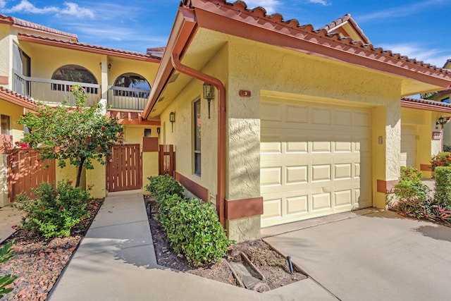 mediterranean / spanish home with a garage