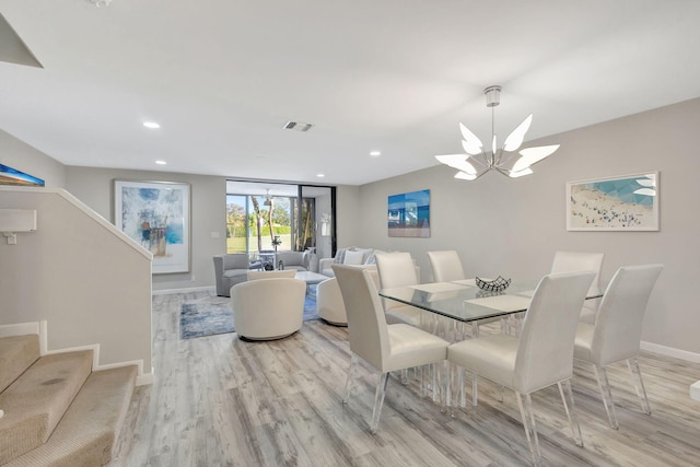 dining space with a chandelier and light wood-type flooring