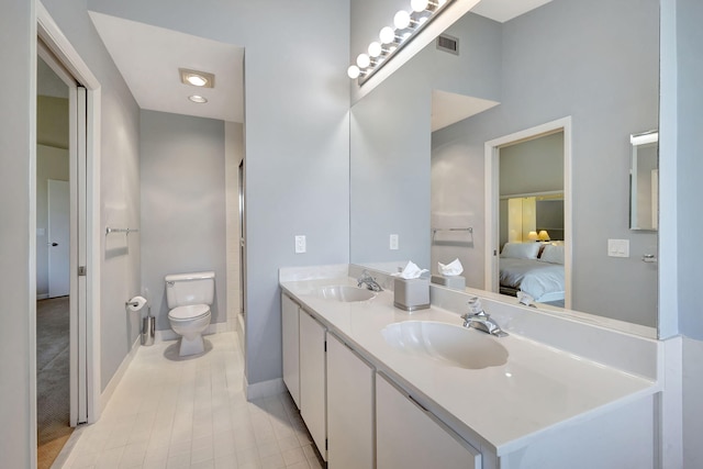 bathroom featuring tile patterned flooring, vanity, and toilet