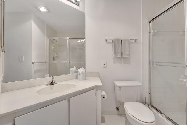 bathroom featuring tile patterned floors, toilet, vanity, and walk in shower