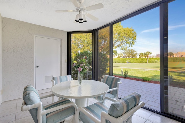 sunroom / solarium with a wealth of natural light and ceiling fan