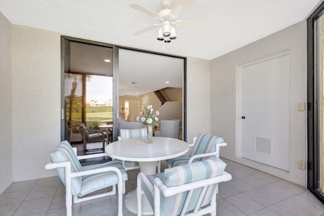 dining area with ceiling fan and light tile patterned flooring