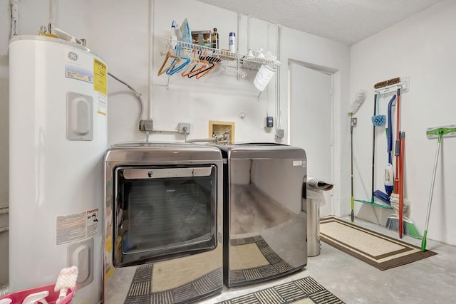 laundry room featuring a textured ceiling, separate washer and dryer, and water heater