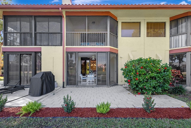 exterior space featuring a patio area and a sunroom