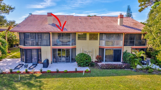 rear view of property with a patio area and a yard