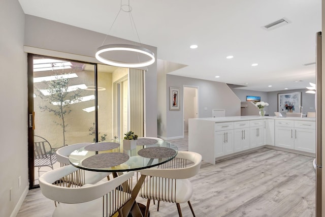 dining area featuring light hardwood / wood-style floors and sink