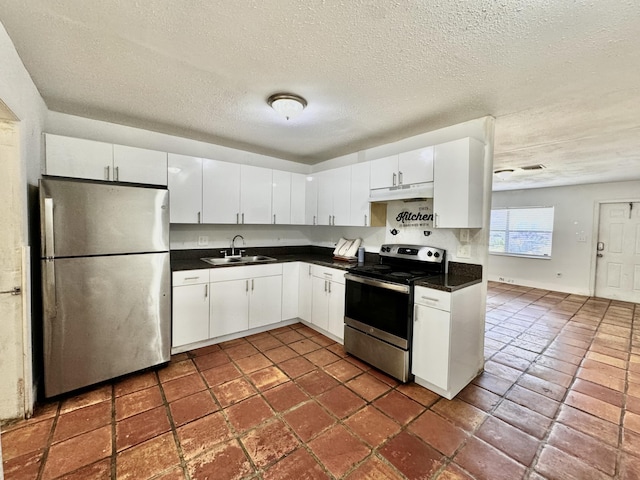 4952 Pimlico Ct, West Palm Beach, FL 33415 - kitchen featuring appliances with stainless steel finishes, under cabinet range hood, dark countertops, white cabinets, and a textured ceiling