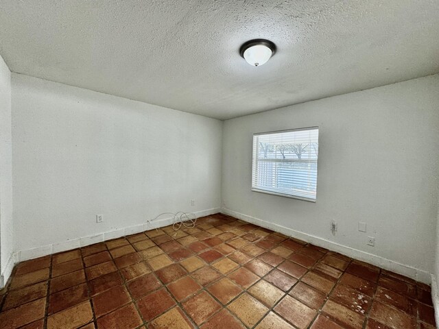 spare room featuring a textured ceiling