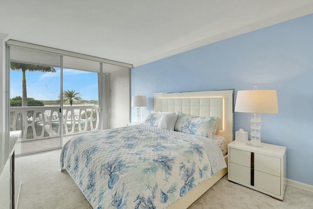 carpeted bedroom with access to exterior and floor to ceiling windows