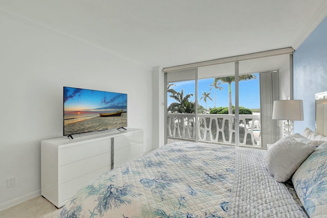 carpeted bedroom featuring crown molding and access to outside