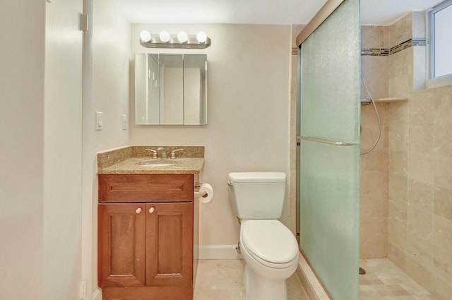 bathroom with vanity, toilet, and a shower with door