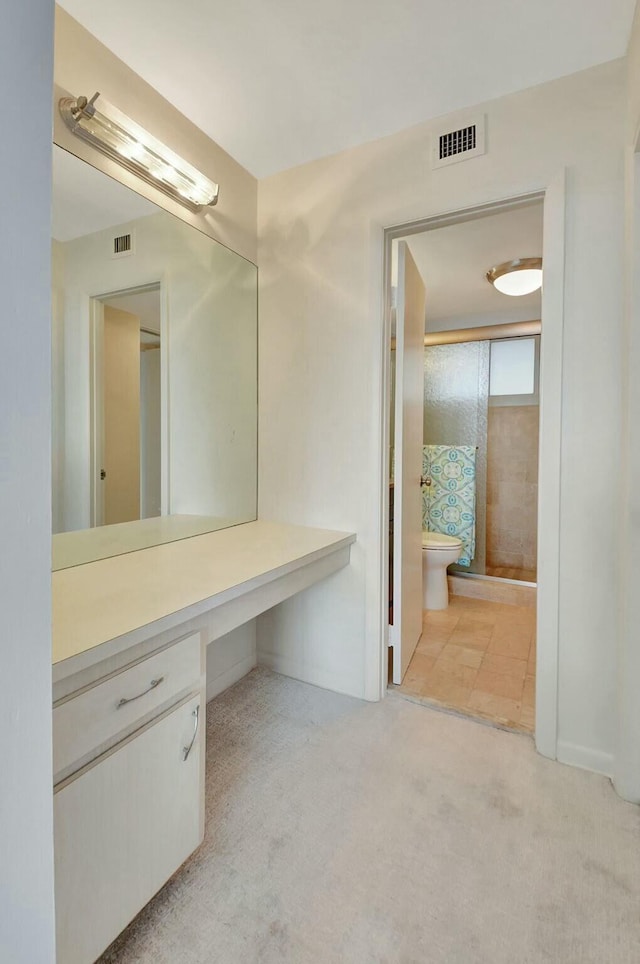 bathroom featuring vanity and toilet