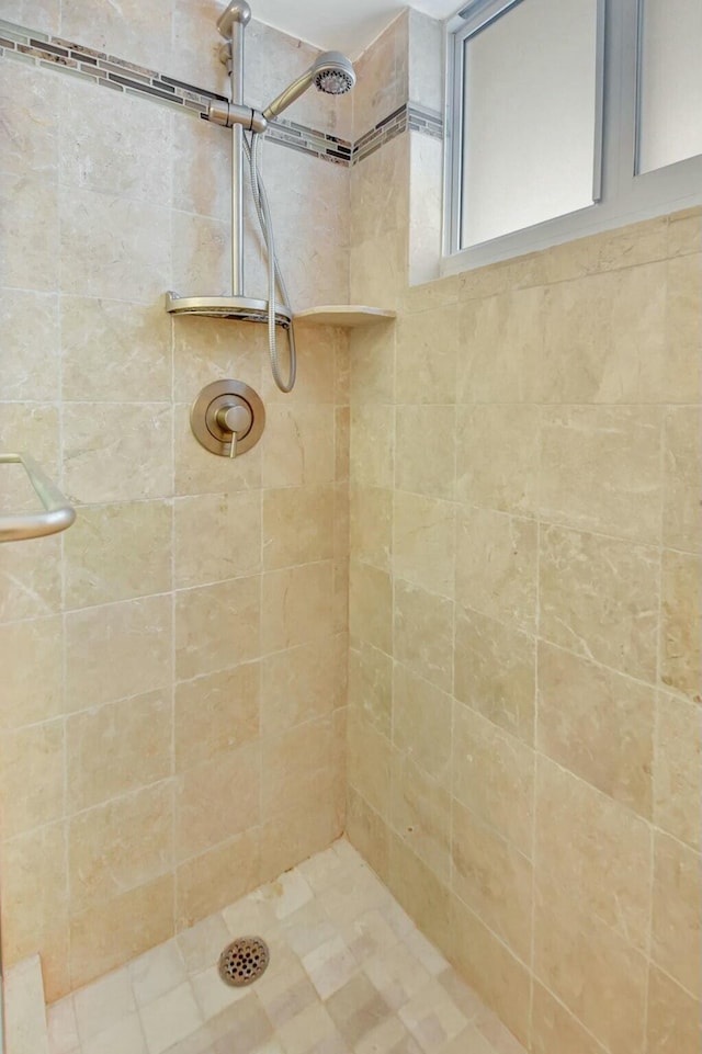 bathroom with a tile shower