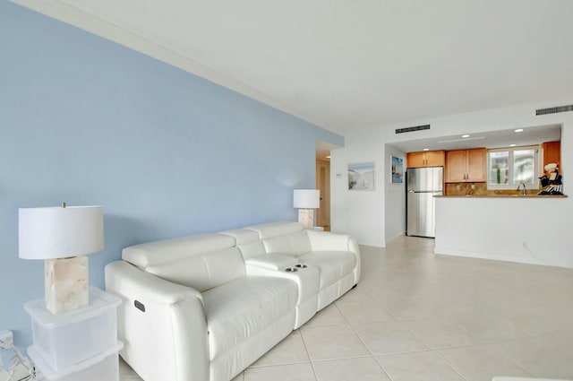 living room with sink and light tile patterned flooring