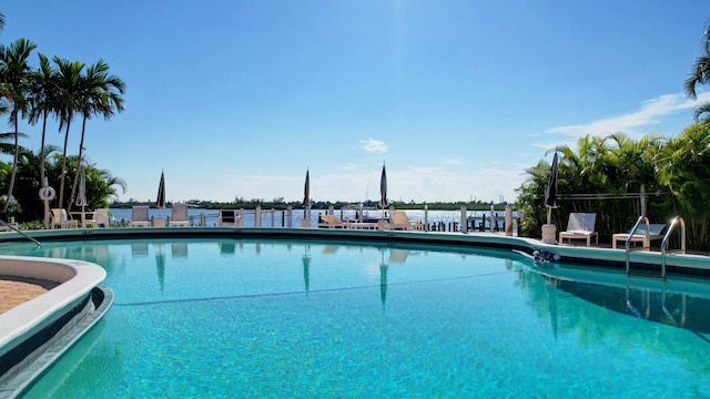 view of swimming pool with a water view