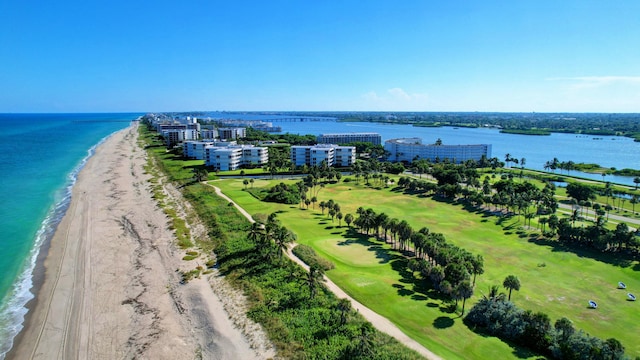 drone / aerial view featuring a water view and a beach view