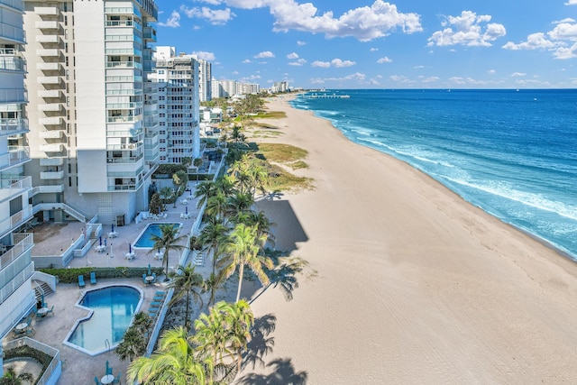 drone / aerial view with a water view and a beach view