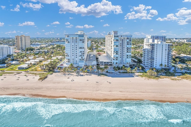 drone / aerial view with a water view and a beach view