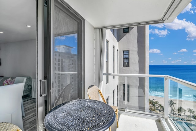 balcony with a water view and a beach view