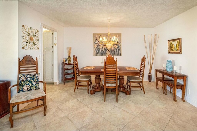 dining room with a textured ceiling and a notable chandelier