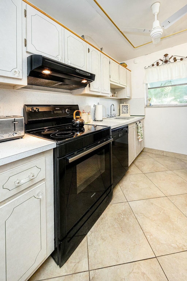 kitchen featuring black appliances, white cabinetry, sink, and light tile patterned floors