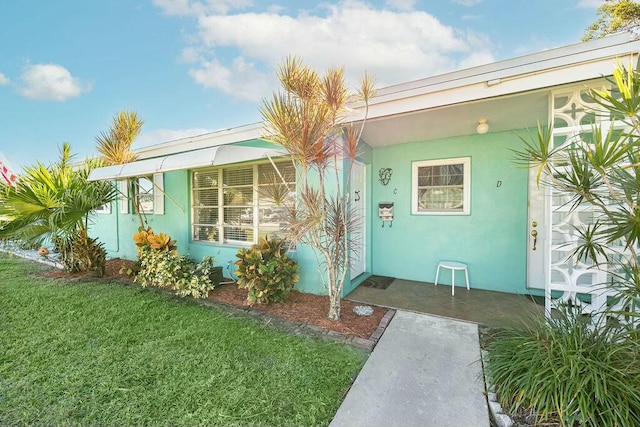 doorway to property featuring a yard