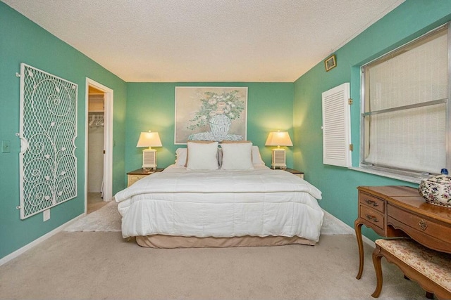 carpeted bedroom featuring a textured ceiling